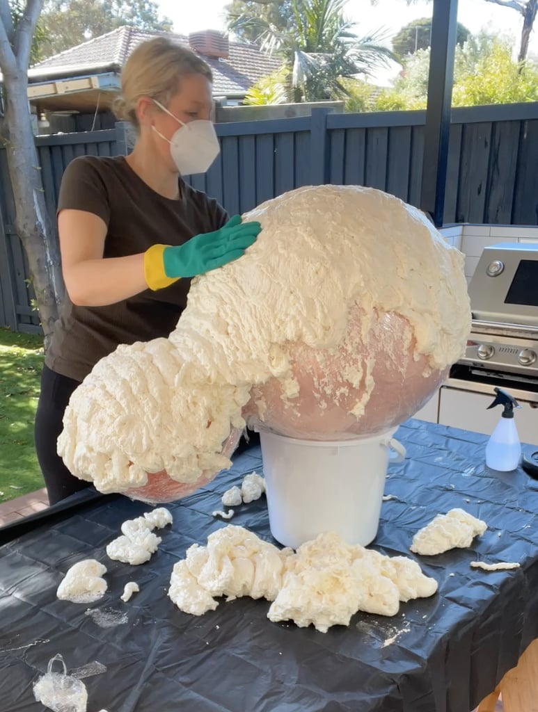 After 10 minutes, use your gloves to smooth out the foam, molding it to the spider's head and body. Let the top half dry overnight, then repeat the foam-and-water technique on the bottom half of the spider.