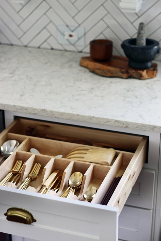 Drawer organizers keep flatware and other tools in order. How pretty is that gold flatware?