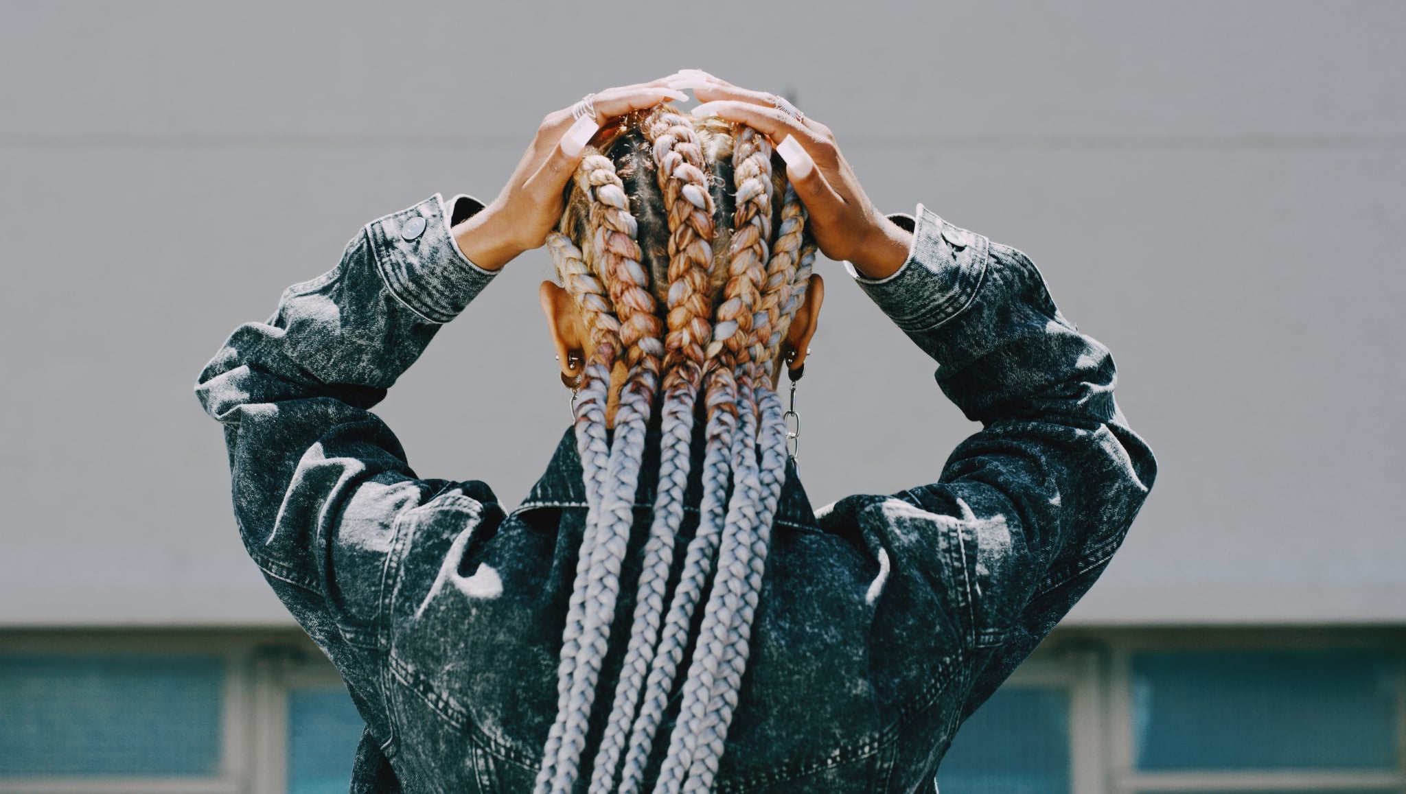 Photo of the Back of Woman's Hair With Hands on Head
