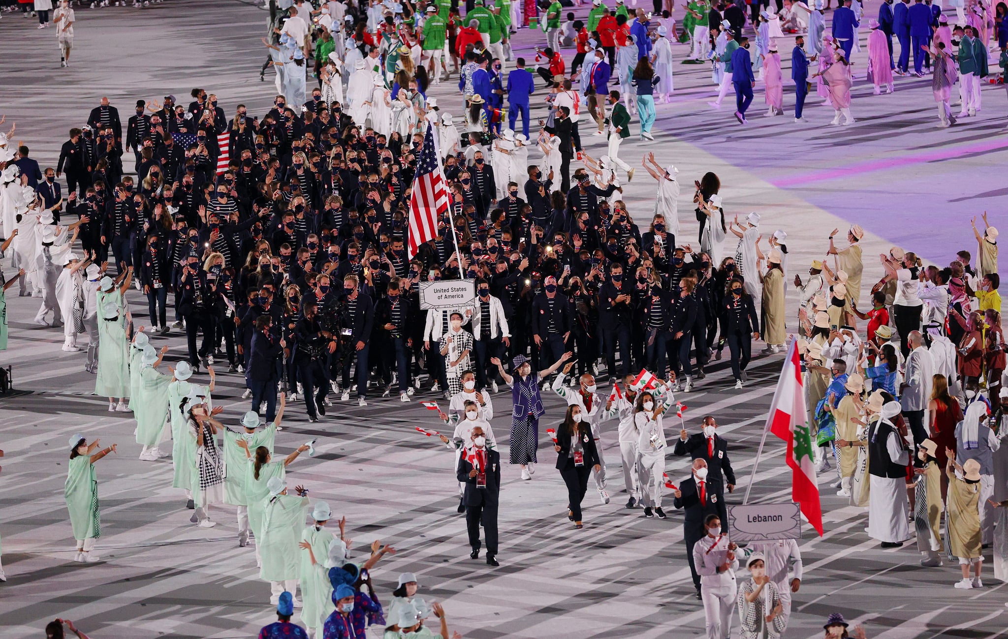 TOKYO, JAPAN - JULY 23: Flag bearers Sue Bird and Eddy Alvarez of Team United States lead their team in during the Opening Ceremony of the Tokyo 2020 Olympic Games at Olympic Stadium on July 23, 2021 in Tokyo, Japan. (Photo by Patrick Smith/Getty Images)
