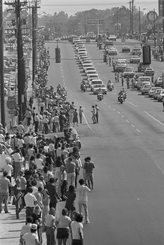 Thousands of mourners lined the streets in Memphis, TN, to watch Elvis's funeral procession.