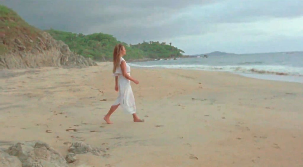 Chrissy Teigen Reveals Pregnancy in a White Dress in "Wild"