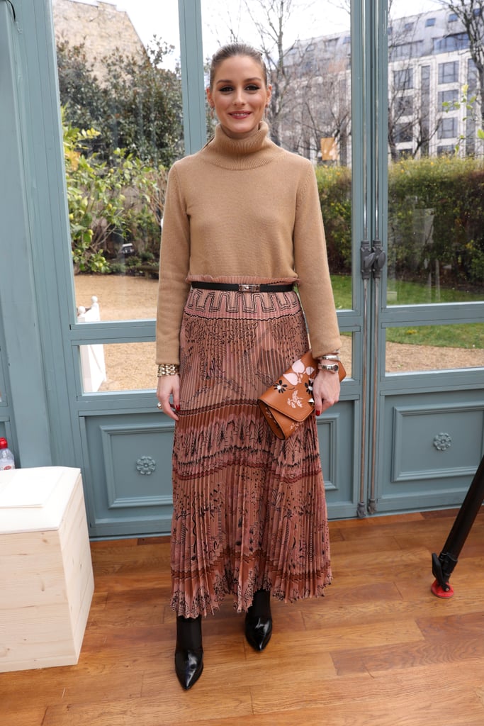 For Valentino, the style guru cinched a statement skirt and added a turtleneck and boots for a perfect transitional look.