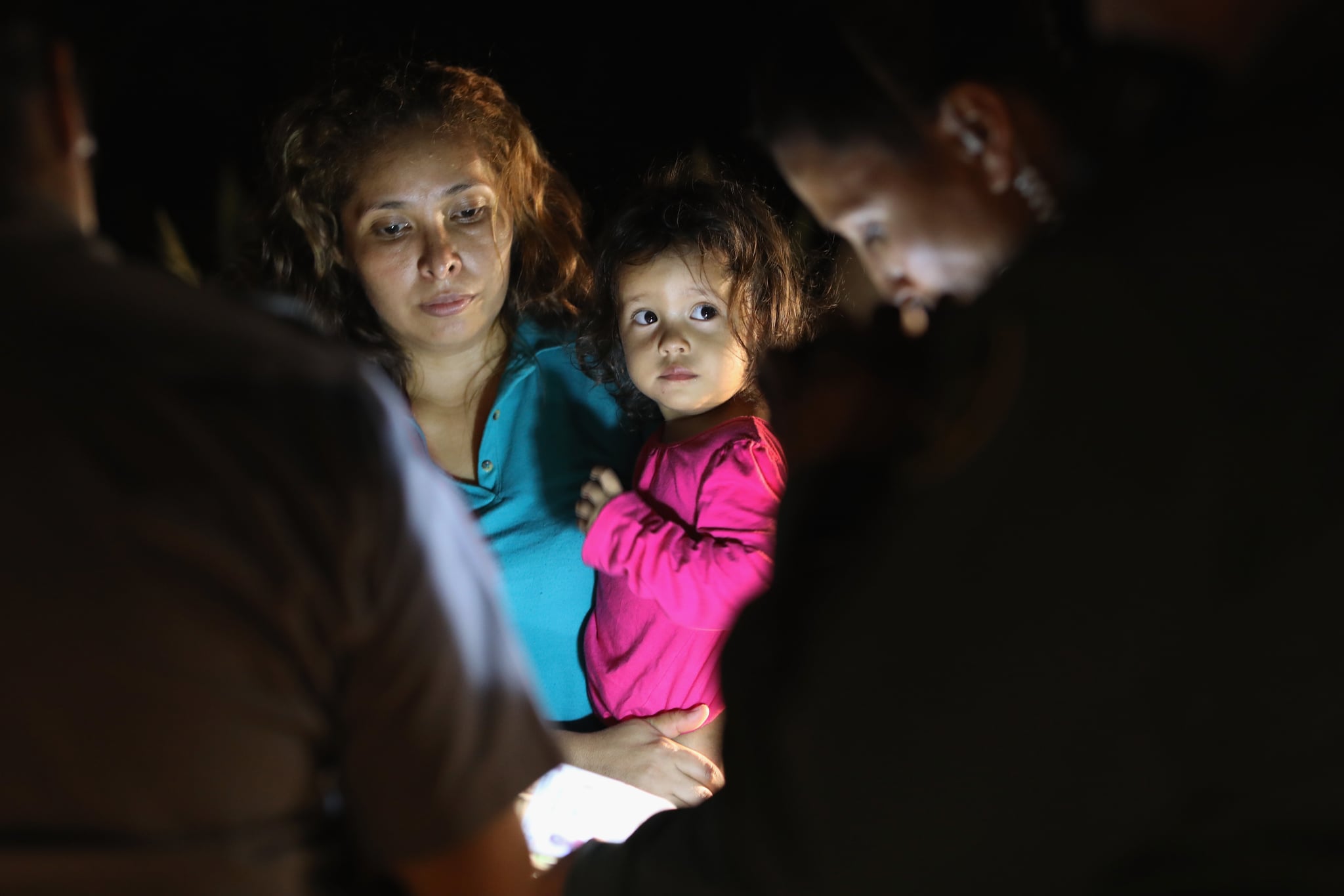 MCALLEN, TX - JUNE 12:  Central American asylum seekers, including a Honduran girl, 2, and her mother, are taken into custody near the U.S.-Mexico border on June 12, 2018 in McAllen, Texas. The group of women and children had rafted across the Rio Grande from Mexico and were detained by U.S. Border Patrol agents before being sent to a processing centre for possible separation. Customs and Border Protection (CBP) is executing the Trump administration's zero tolerance policy towards undocumented immigrants. U.S. Attorney General Jeff Sessions also said that domestic and gang violence in immigrants' country of origin would no longer qualify them for political asylum status.  (Photo by John Moore/Getty Images)