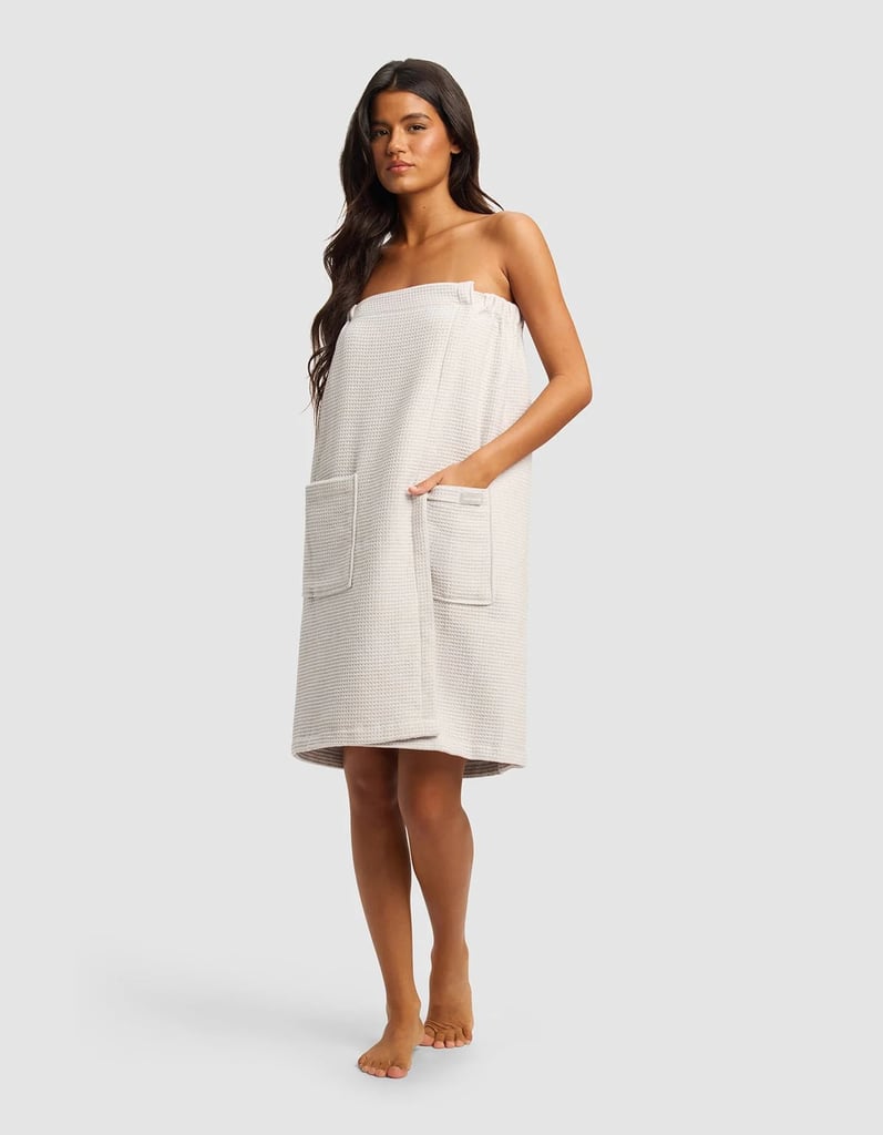 Cozy Earth Waffle Bath Wrap ($74)
A towel wrap is your stereotypical dorm room essential, but it's also the perfect upgrade for anyone who craves maximum convenience while getting ready in the bathroom. The top of the waffle towel sits secure thanks to an adjustable snap clasp, while large pockets give you room to store makeup products, tools, or anything else you typically grab and go.
