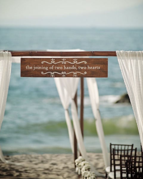 Have a special quote or phrase that speaks to you? Hang it from a wooden archway to make it part of your big day.
Photo by Photoshoots Vallarta via Style Me Pretty