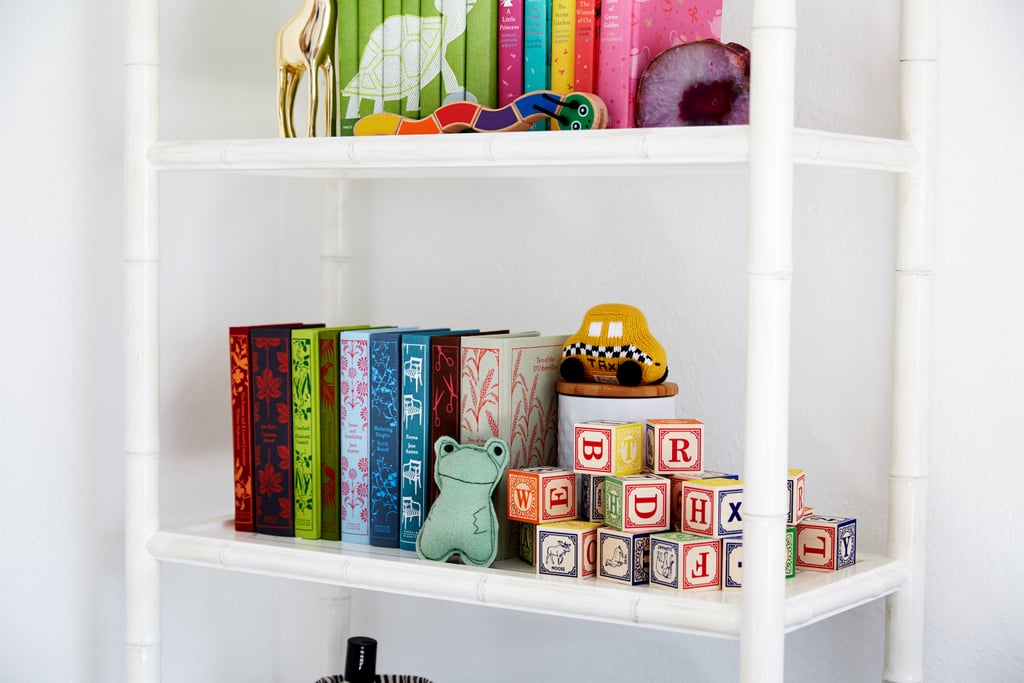 Colorful design classics share shelf space with a set of stacked blocks, brilliantly stored away while doubling as visual appeal.
"I love that this room is a party full of color. And it's also superrelaxing. I'm so excited to curl up on the sheepskin rug and read with our daughter."
— Coco Rocha