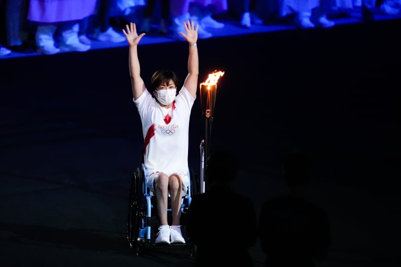 TOKYO, JAPAN - JULY 23: Paralympic athlete Wakako Tsuchida carries the Olympic torch during the Opening Ceremony of the Tokyo 2020 Olympic Games at Olympic Stadium on July 23, 2021 in Tokyo, Japan. (Photo by Wei Zheng/CHINASPORTS/VCG via Getty Images)