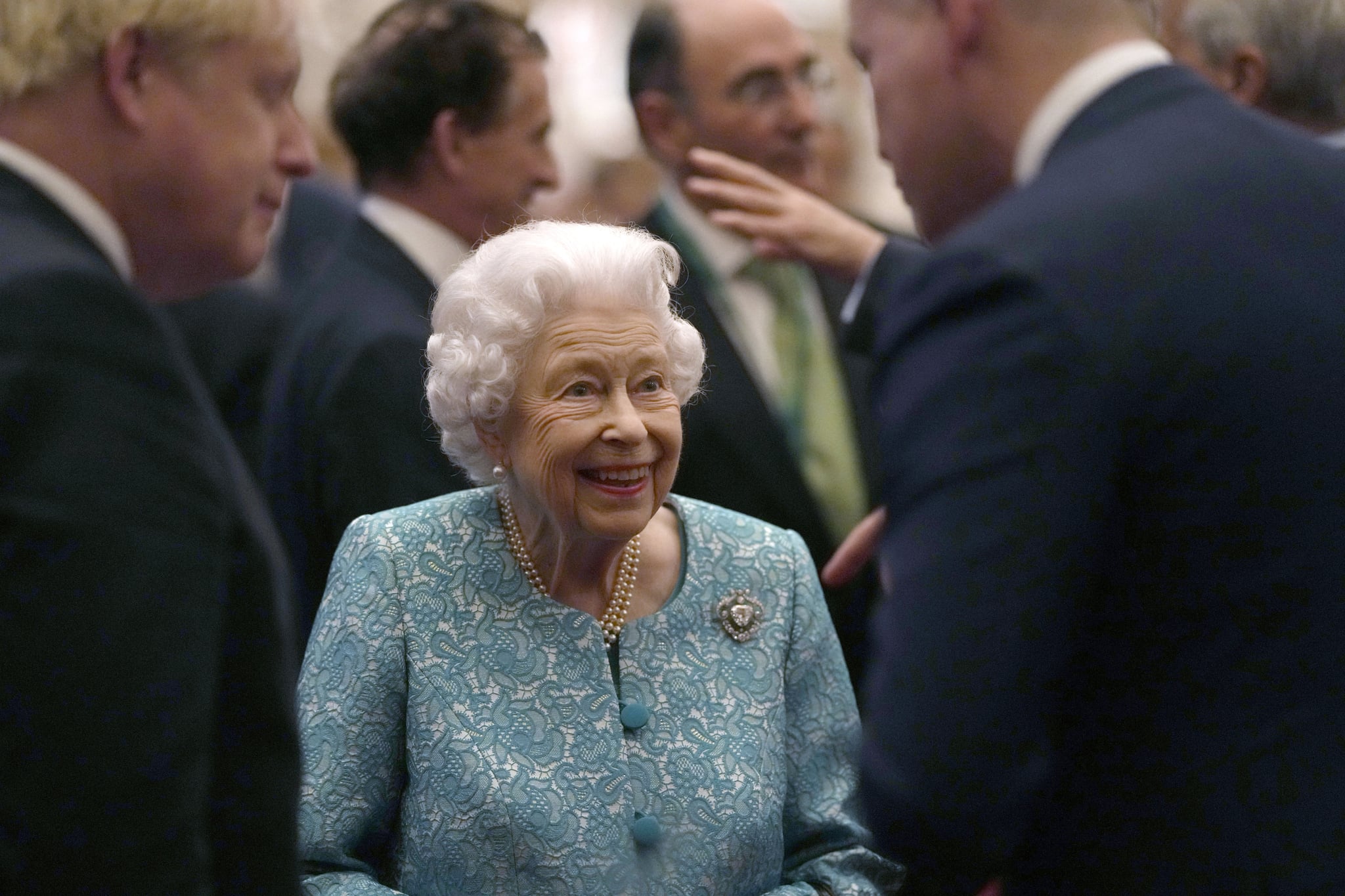 WINDSOR, UNITED KINGDOM - OCTOBER 19:  Britain's Queen Elizabeth II and Prime Minister, Boris Johnson greet guests during a reception for international business and investment leaders at Windsor Castle to mark the Global Investment Summit on October 19, 2021 in Windsor, England.  (Photo by Alastair Grant - Pool/Getty Images)