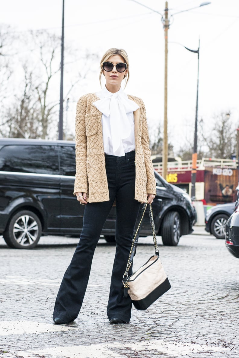 A Pretty White Blouse, a Beige Coat, and Black Flared Jeans