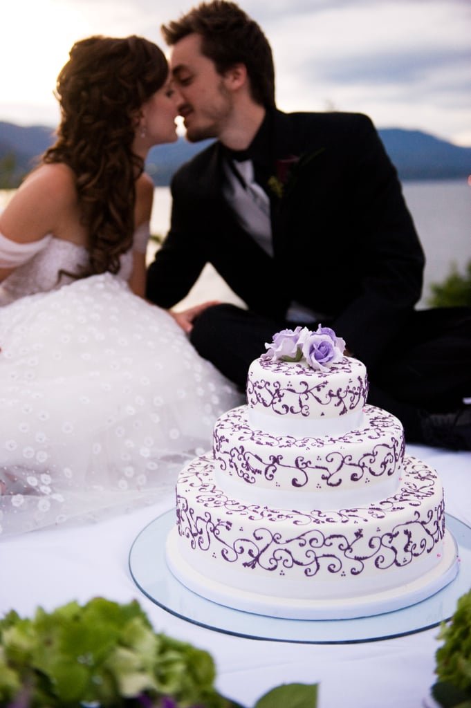 Dyed roses match the delicate lavender piping for this romantic wedding cake.