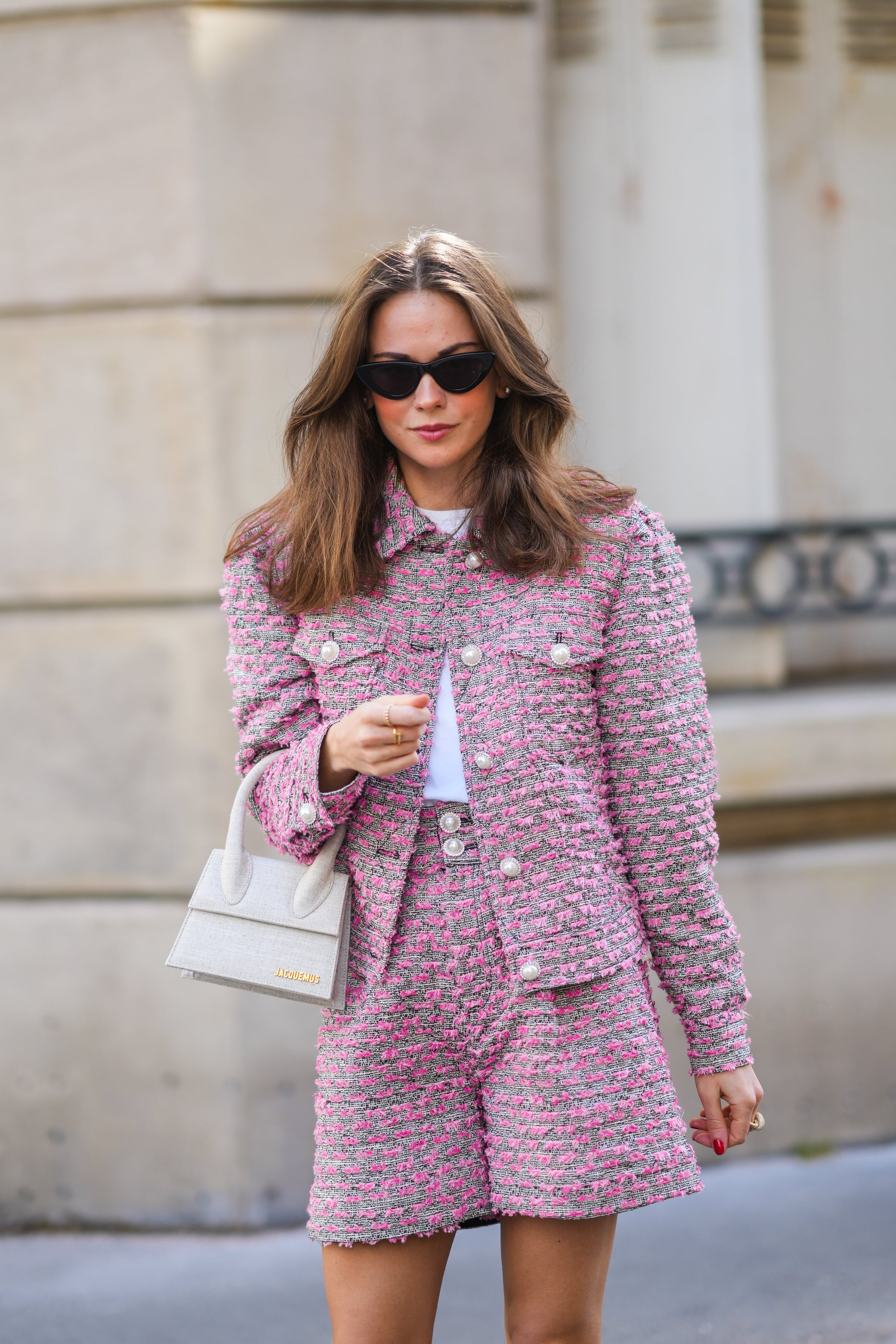 PARIS, FRANCE - MARCH 30: Therese Hellström @tesshell wears sunglasses, a white t-shirt, a gray purple / pink tweed knit jacket with pearls, purple / pink tweed knit shorts, a white Jacquemus bag, on March 30, 2021 in Paris, France. (Photo by Edward Berthelot/Getty Images)