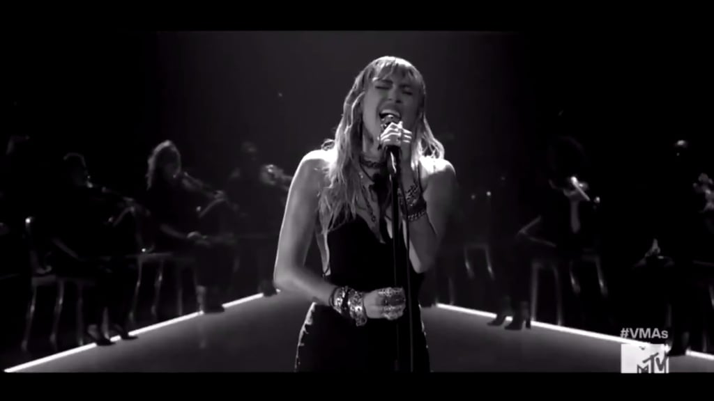 Miley Cyrus is the queen of emotional live performances and her time onstage at the 2019 MTV VMAs was no different. On Monday night, the 26-year-old singer performed her newly released single "Slide Away" live for the first time ever, and it was every bit as poignant as expected. 
The singer hit the stage in a black dress and sang the heart-wrenching song, which seemingly addresses her recent split from actor Liam Hemsworth. Hemsworth and Cyrus dated on and off for ten years before marrying in December 2018. However, in August, Hemsworth filed for divorce after seven months of marriage citing, "irreconcilable differences."
Watch her powerful performance above and check out some photos of the show ahead.
