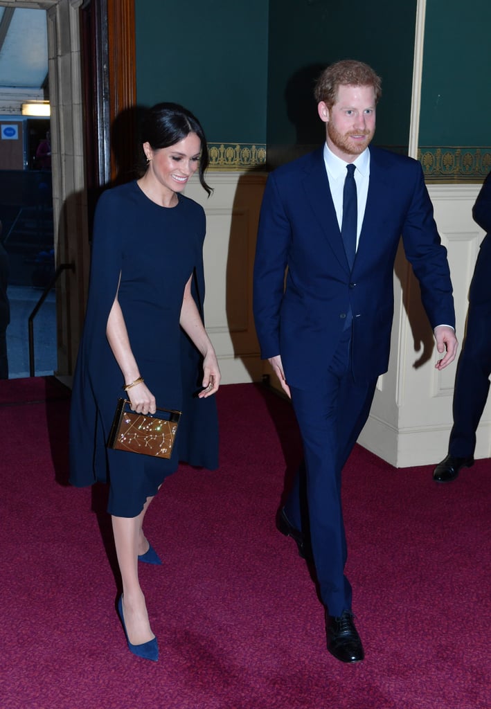 For a concert celebrating the queen's 92nd birthday, Harry wore another blue suit which perfectly matched with Meghan's Stella McCartney cape dress.