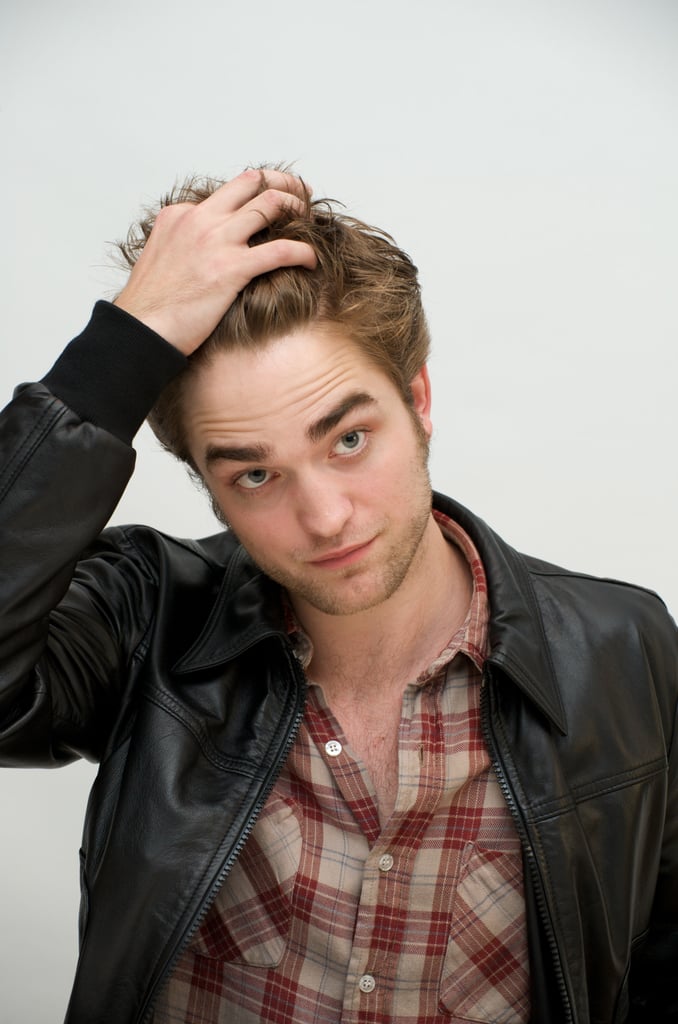 Rob took a moment to play with his hair during a November 2009 photocall for New Moon.