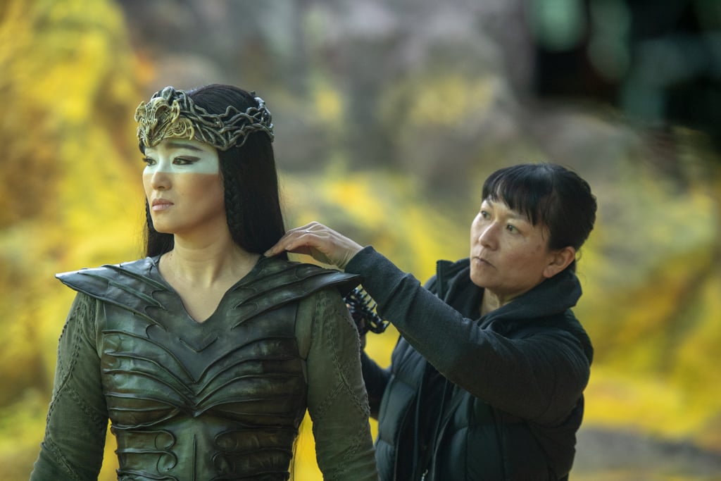 Much of Xianniang's character, on the other hand, was mainly influenced by her animal reference. "Because she's a shapeshifter her animal reference is the hawk," said Kum. "So, the shape of the eye makeup and all the colors in her eye makeup were influenced by her costume, the armor, but also the hawk feathers."
The white mask across Xianniang's eyes, however, was a historic reference to clay figurines Kum found when researching. "I really liked how it was a white mask and, in many cultures, white is revered as something being beautiful. So, it was a bit of a way of a twist on that, layering that over her eyes." Much of Xianniang's character, on the other hand, was mainly influenced by her animal reference. "Because she's a shapeshifter her animal reference is the hawk," said Kum. "So, the shape of the eye makeup and all the colors in her eye makeup were influenced by her costume, the armor, but also the hawk feathers."
The white mask across Xianniang's eyes, however, was a historic reference to clay figurines Kum found when researching. "I really liked how it was a white mask and, in many cultures, white is revered as something being beautiful. So, it was a bit of a way of a twist on that, layering that over her eyes."