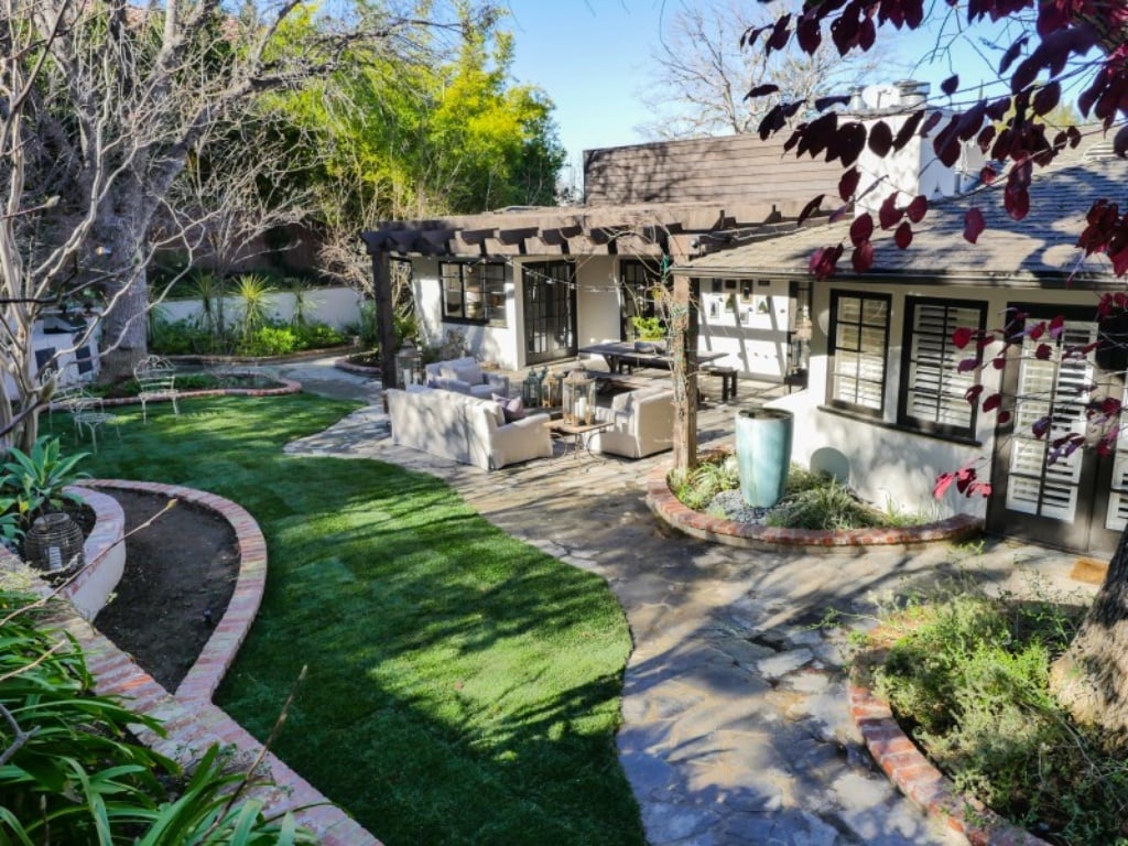 A lawn and awning complete the outdoor space. 
Source: Sotheby's Realty
