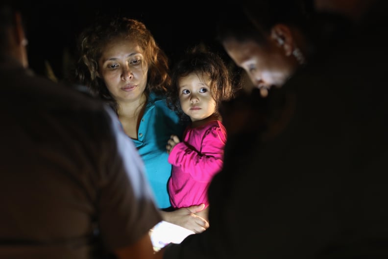 MCALLEN, TX - JUNE 12:  Central American asylum seekers, including a Honduran girl, 2, and her mother, are taken into custody near the U.S.-Mexico border on June 12, 2018 in McAllen, Texas. The group of women and children had rafted across the Rio Grande 