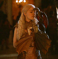 She carries them around, like a good mother would.  Game of Thrones' Daenerys and Her Dragons 
