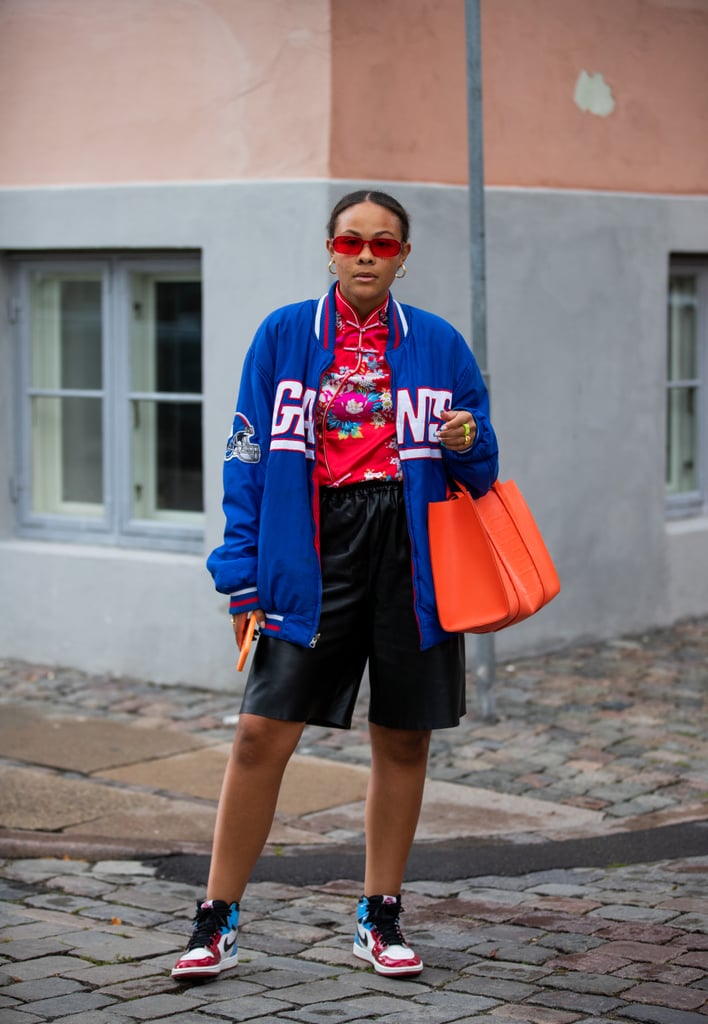 Outfit idea: Try leather Bermuda shorts with high-top sneakers and your favorite team sport jacket. You can add structure here by finishing with a geometric-shaped tote bag.