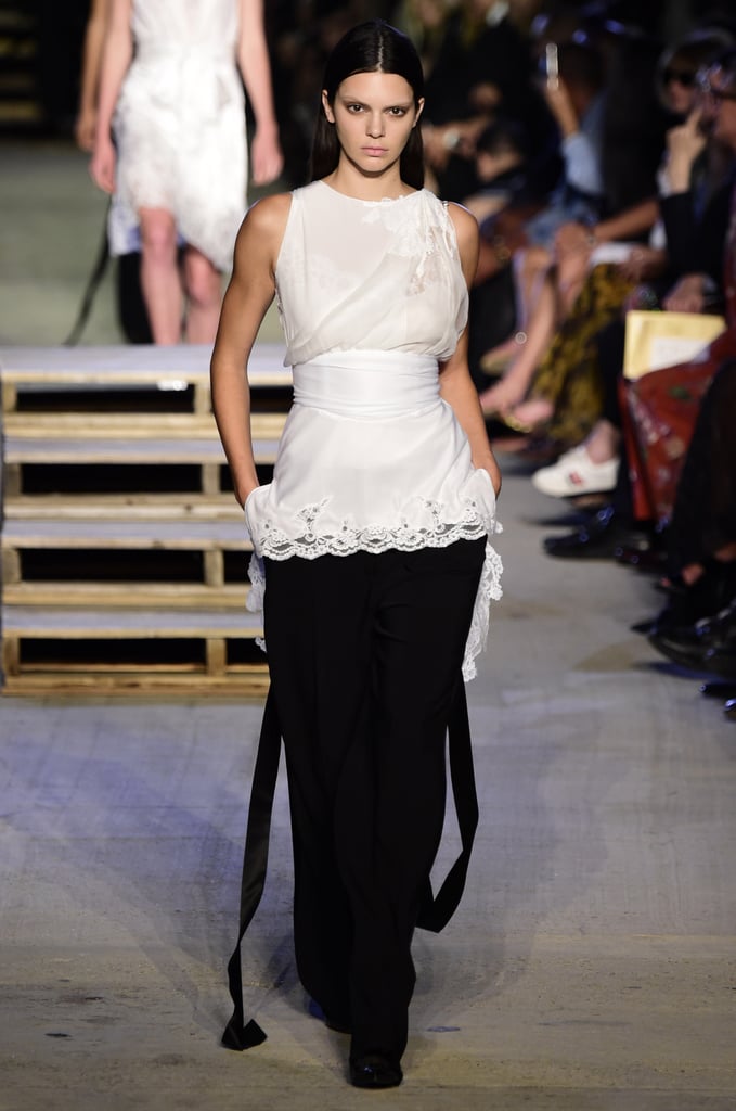 Kendall's full outfit at Givenchy included a white top and full-leg black pants.