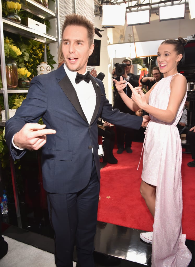 Pictured: Sam Rockwell and Millie Bobby Brown