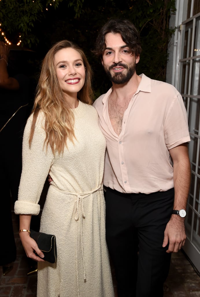 Elizabeth Olsen has revealed new details about her marriage to musician Robbie Arnett. In a June 28 interview with SiriusXM, Olsen confirmed that she and Arnett eloped prior to the COVID-19 lockdown. "We never really talked much about our marriage," Olsen said. "We eloped, and then we had a wedding at another time, but it was before COVID. I just never talked about it."
It turns out there was a specific reason for the timing of the couple's covert nuptials. "I had to work in England and there are visa issues with that," Olsen explained. "He wouldn't have been able to come at all actually. And also everything was so backed up. You couldn't even like try to get married then. But it ended up working out."
The confession comes about a year after Olsen seemed to casually reveal that she and Arnett had tied the knot during a June 2021 chat with Kaley Cuoco for Variety's "Actors on Actors" video series. While doing the interview from her bathroom, Olsen referred to her longtime boyfriend as her husband as she noted how he'd put "Little Miss Magic" decor in the background. "I also just noticed that my husband put 'Little Miss Magic.' You know, the 'Little Miss' books?" she said to Cuoco. "They're these classic books, but 'magic' because of 'WandaVision,' because he's such a f*cking cutie!"
The surprise marriage news wasn't too much of a shock for fans of Olsen and Arnett, as they'd been notoriously private about their relationship over the years. The "Doctor Strange in the Multiverse of Madness" actor reportedly first met the musician while on vacation in Mexico. The two eventually sparked romance rumors when E! News reported that they'd been spotted walking arm in arm in New York City in March 2017. In 2019, People confirmed that they were engaged, but the couple never commented on the news themselves. 
Though they've been quiet about their love, they have given fans a few glimpses through public appearances. See some of their cutest pictures ahead.

    Related:

            
            
                                    
                            

            Elizabeth Olsen on Being "Spoiled" and "Protected" by Mary-Kate and Ashley Growing Up