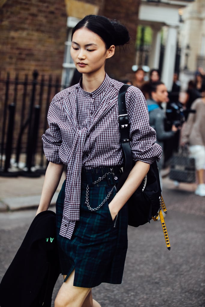 Play with patterns at work and style a gingham top with a checked mini.
