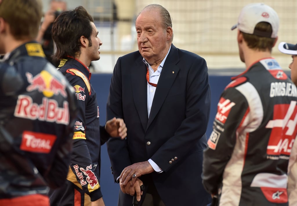 King Juan Carlos chats with Spanish Formula 1 driver Carlos Sainz Jr. in Bahrain.