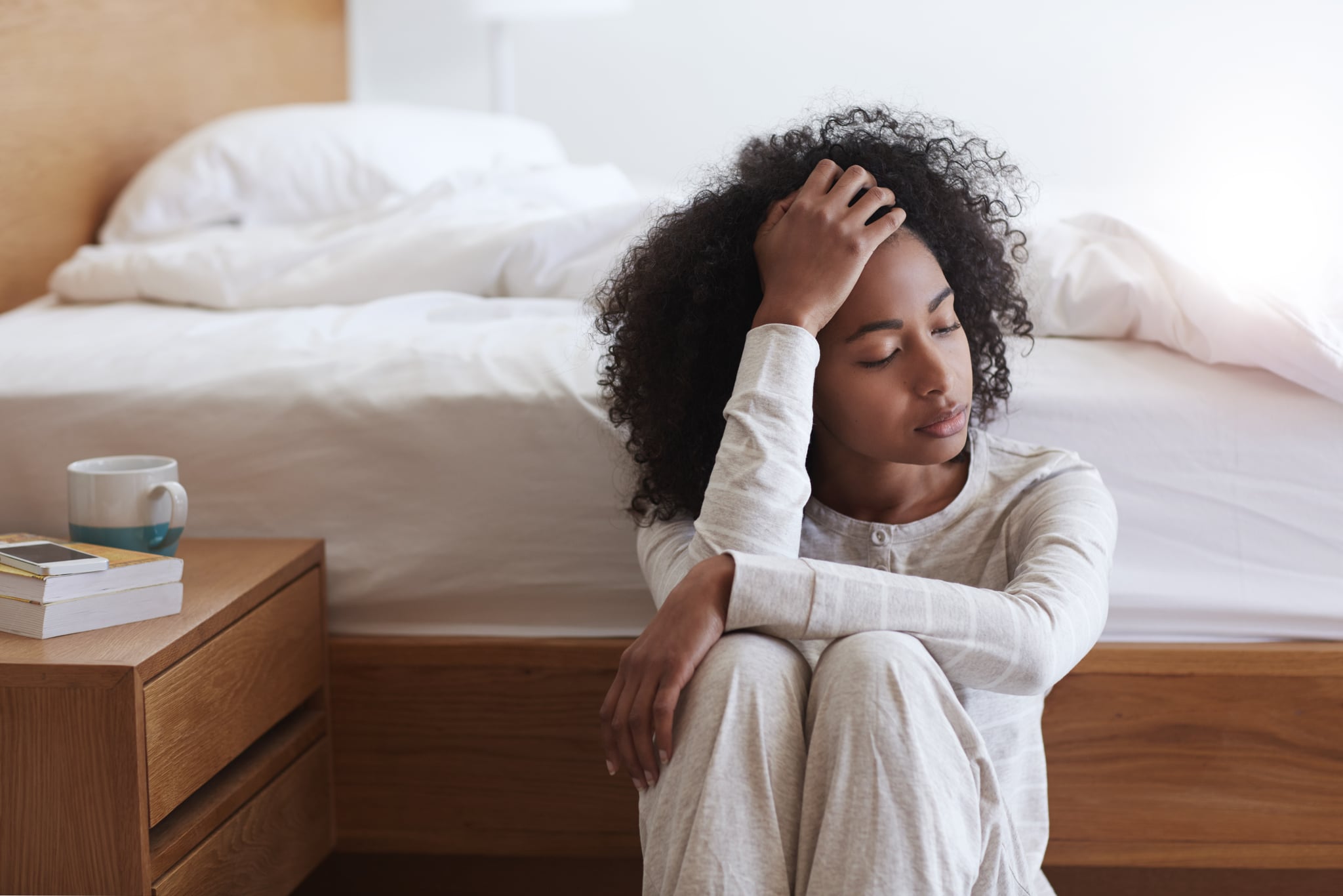 Shot of a tired young woman sitting on the floor leaning against her bedhttp://195.154.178.81/DATA/i_collage/pu/shoots/805716.jpg