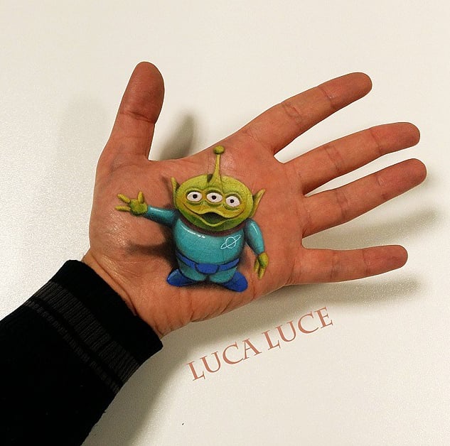 Just a Little Green Man saying hello from the palm of a hand.
