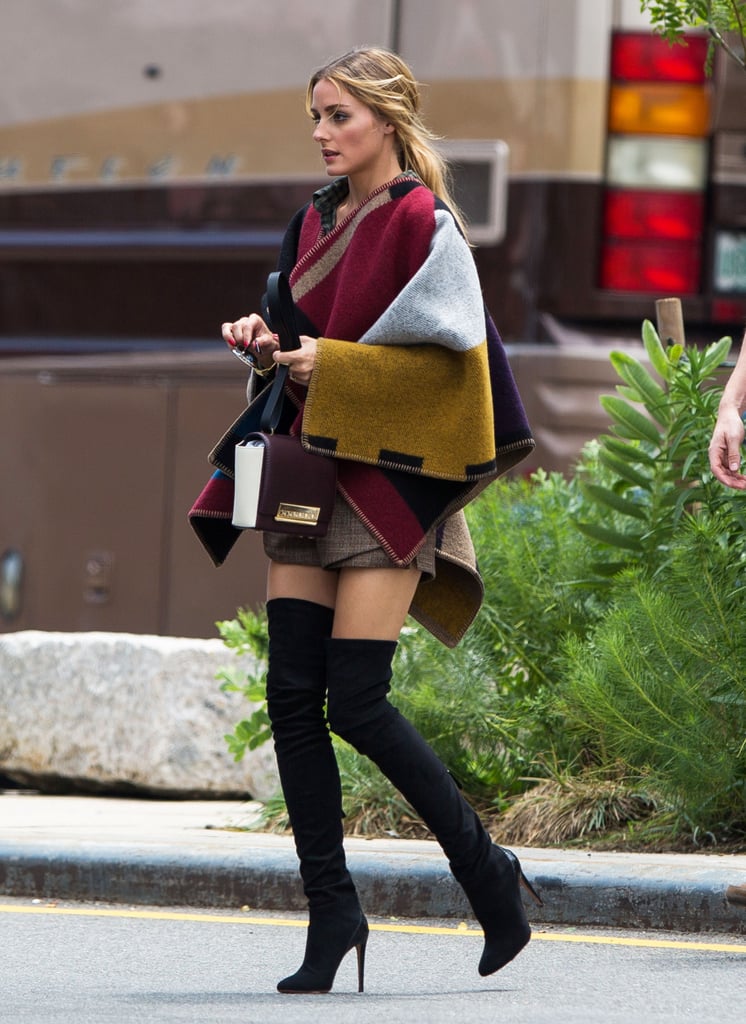 How else would you style a poncho? Olivia amped up the shapeless silhouette with a thigh-high hemline, over-the-knee boots, and a CH Carolina Herrera Casati bag.