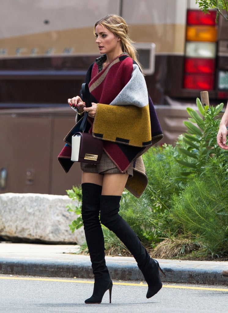Sexy thigh-high boots paired with an oversize poncho somehow work on the effortlessly stylish Olivia.