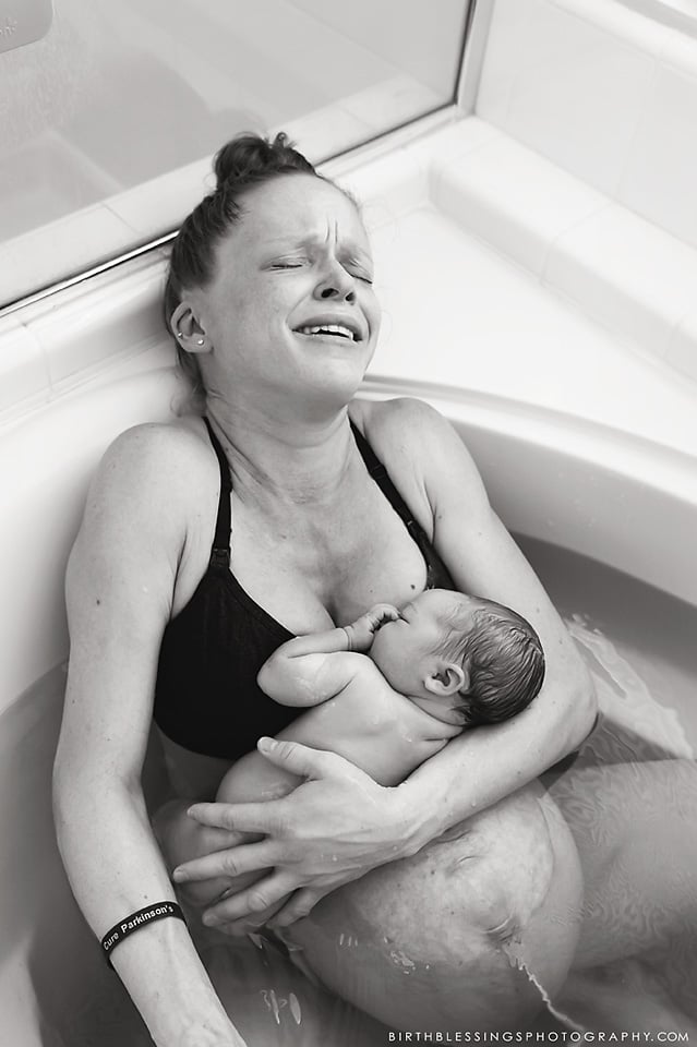 Birth Photos of Dad Delivering Twins in Tub