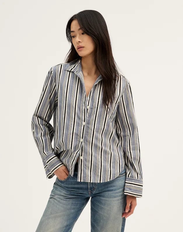 Madewell The Signature Y-Neck Shirt ($74, originally $98)
I am a strong believer that you can never have too many button-down shirts in your closet. This adorable blue, white, and black stripe print feels very on-trend right now. Bonus points for the slightly boxy cut, which guarantees a cozy, oversize fit.