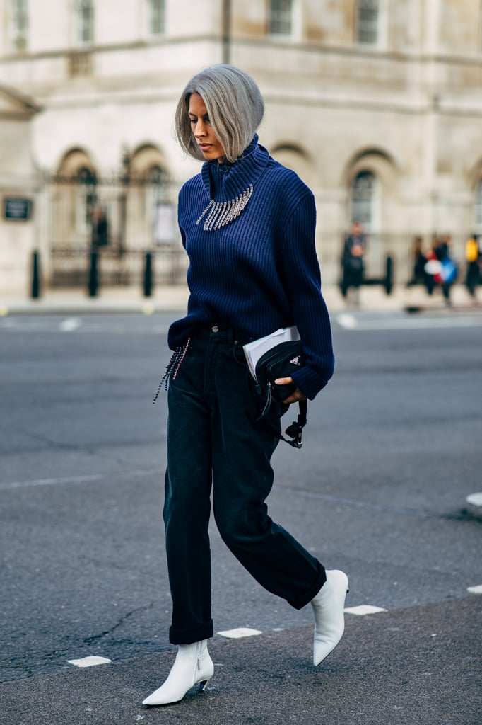 String a statement necklace around the collar of your sweater, and pair sharp white booties with thick trousers.