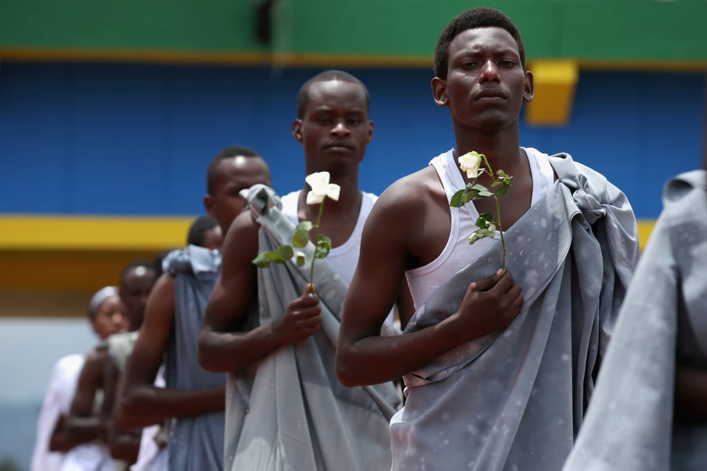 Performers carried white flowers as they entered Amahoro Stadium, where tens of thousands of Rwandans gathered to remember the 100-day massacre.