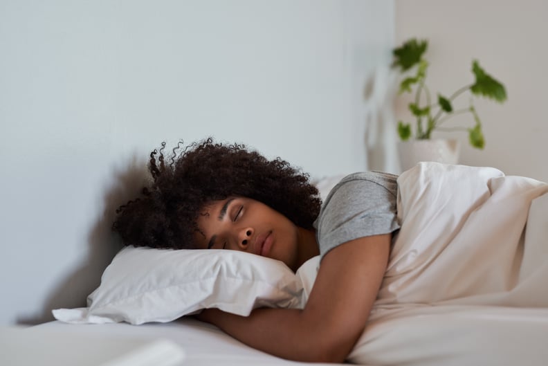 Woman sleeping in her bed at home.