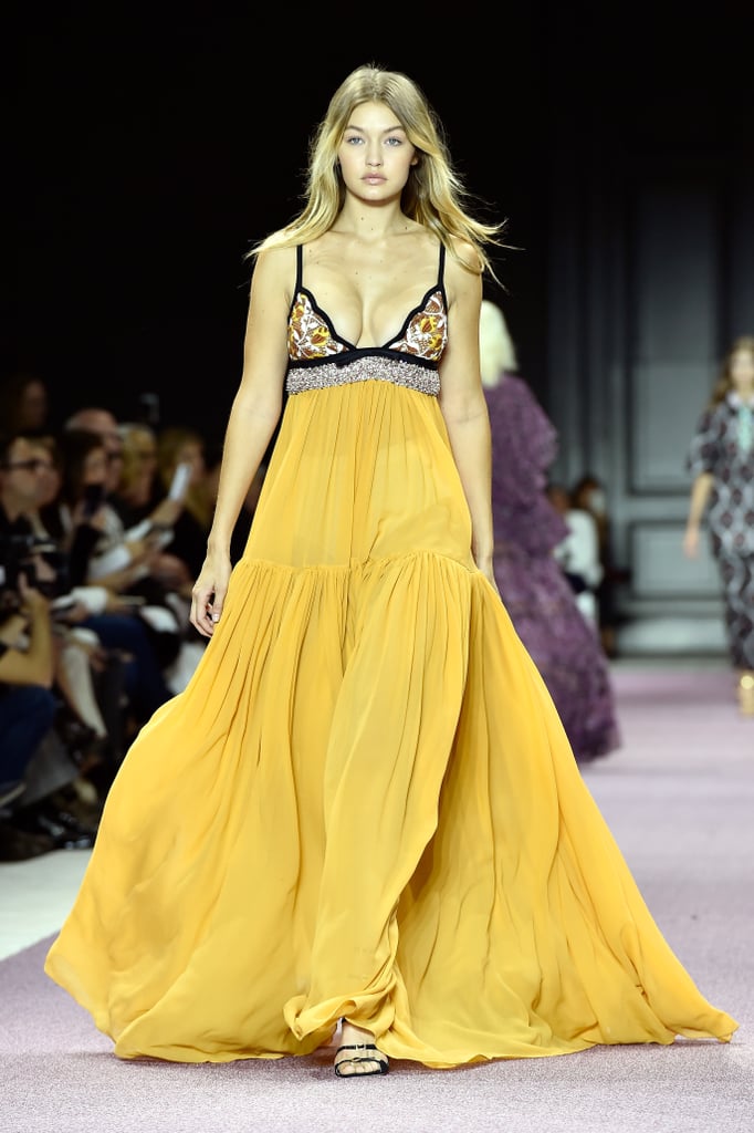 Gigi's Giambattista Valli look clearly stole the spotlight at the show; and maybe that's why she walked the runway last. The floaty, sheer gown swept the floor, and the upper bodice boasted glittering beaded detail that played up Gigi's glow. She wore buckled patent leather heels.