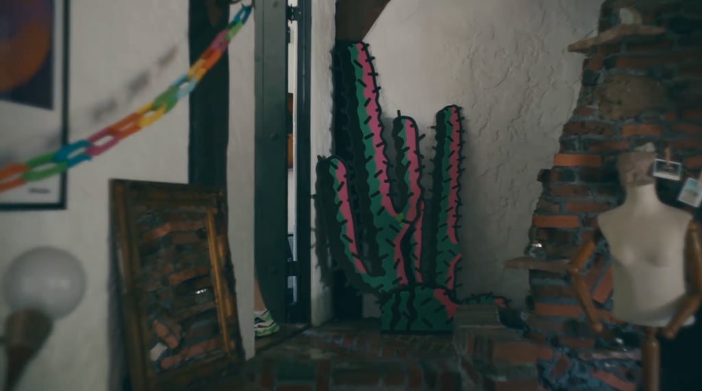 In the corner there's some art, including more paper chains, a dress form, and a multicolor cactus.