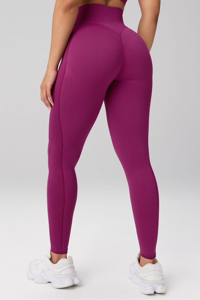 Fabletics Cold Weather Seamless Scrunch High Waisted Legging ($105)
While we love a super-thin pair of leggings as much as the next person, there are certain situations that require a thicker layer. Knowing this, Fabletics took their fan-favorite, glute-defining leggings and made them cold-weather-approved. Use them as a layer for outdoor activities or under winter pants for added warmth. 
Pros: Customers praise the thicker material for being more comfortable than the original. 
Cons: If you run hot and want something to keep you cool as you move, this fabric won't be for you.
Material: Nylon, polyester, and spandex. 
Length: 27"-32" 
Colorways: 6
Sizes: XXS-4X
Who it's best for: Anyone searching for a heavier winter layer to keep warm during cold season runs, hikes, or any outdoor adventures.