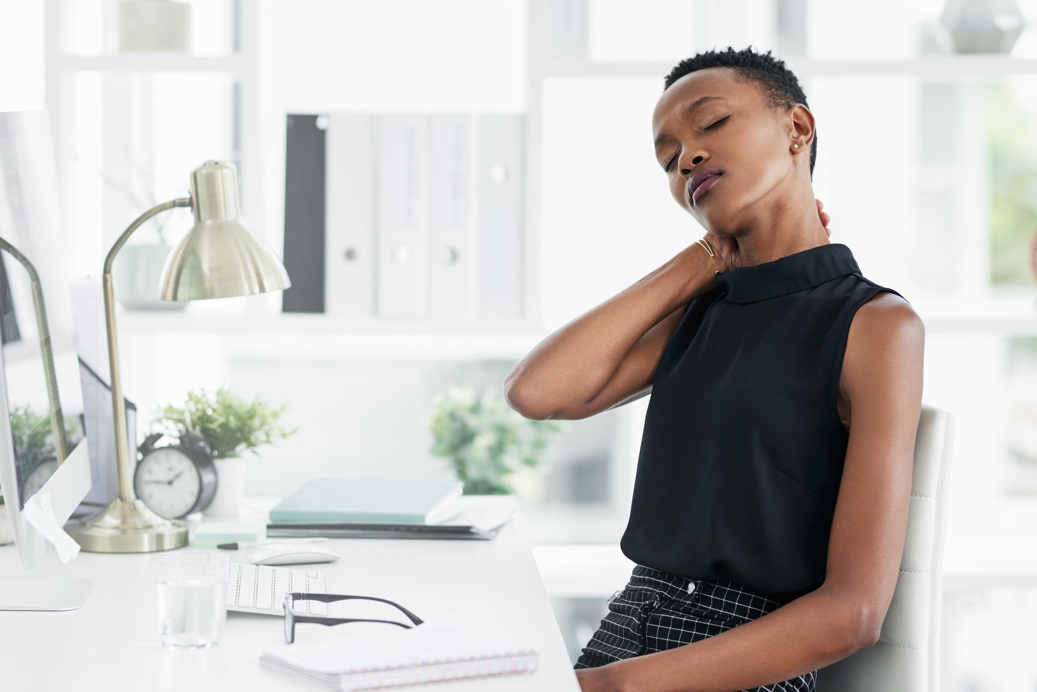 Shot of a young businesswoman experiencing stress at work