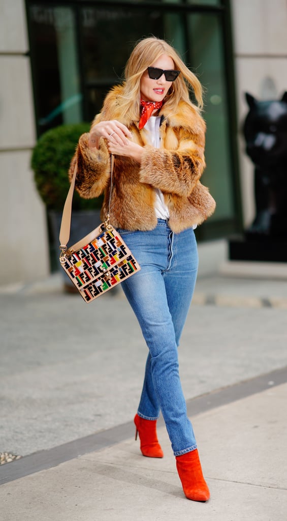 Rosie Huntington-Whiteley added a pop of color to her outfit with red boots and a Fendi bag.