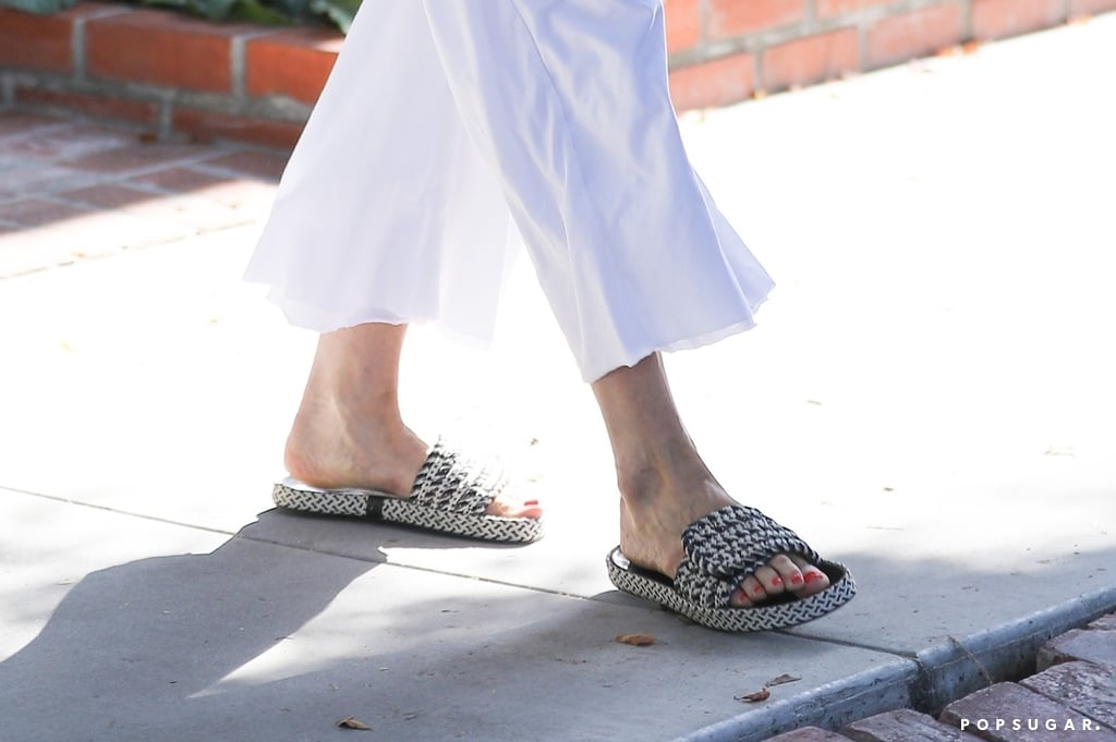 Jennifer Aniston in White Jumpsuit and Isabel Marant Slides