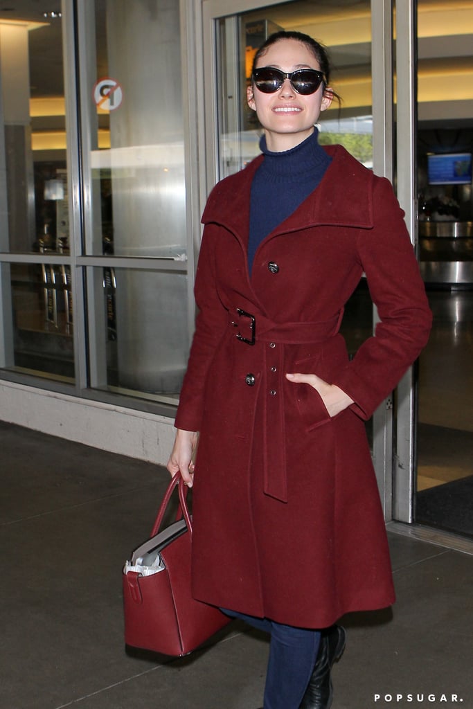 Emmy Rossum smiled widely at LAX on Friday.