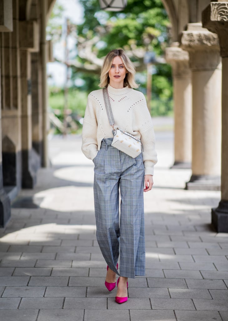 Take a cue from this street style star and accentuate the slimming effect of high-waisted pants by tucking everything in — even a chunky knit. This look is perfect for the office.