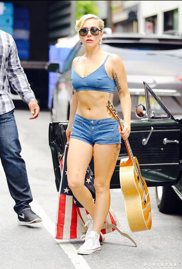 Lady Gaga was feeling patriotic during her latest outing in NYC on Sunday. The singer, who recently returned from Mexico, was spotted out and about with her guitar and American flag jacket in hand. Clad in a denim J Brand crop top and matching shorts, the newly single star gave photographers a peek at her killer abs as she headed to a recording studio in the West Village — perhaps she was working on new music? Lady Gaga was in the news earlier this month after reports surfaced that she and Taylor Kinney ended their engagement. She later took to Instagram to address the news, saying, "Just like all couples we have ups and downs, and we have been taking a break." While there's a possibility these two may get back together, only time will tell.