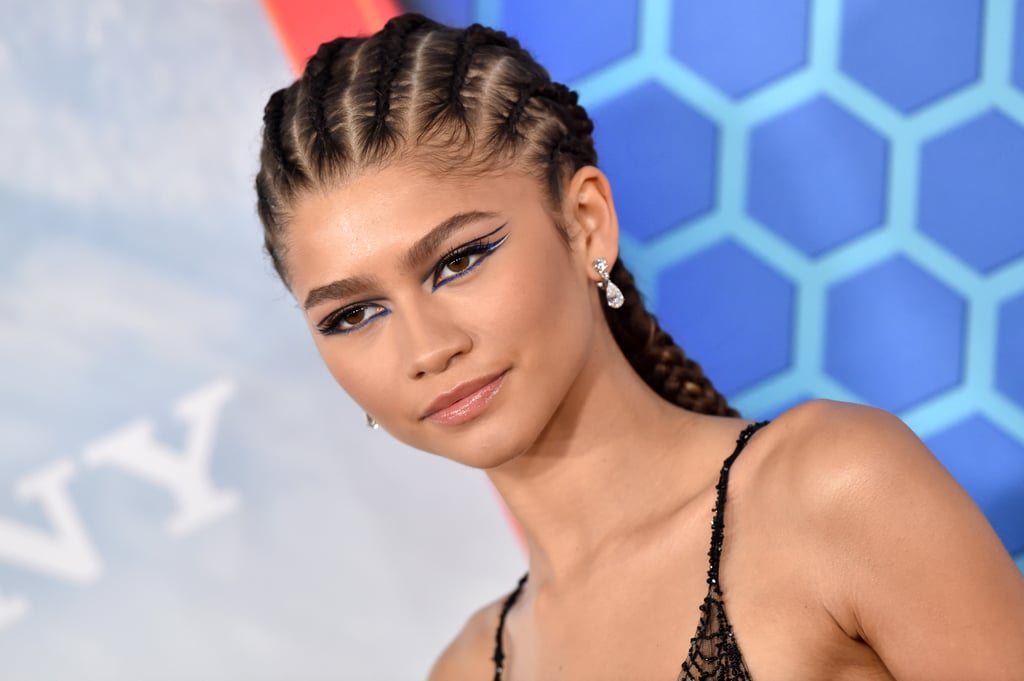 Zendaya's blue eyeliner has seriously magical metallic powers. On Monday, the stars were out in full force for the Spider-Man: No Way Home premiere in Los Angeles, and Zendaya had us mesmerized from head to toe. The actress arrived in an extremely on-brand web-covered Maison Valentino dress with a black lace masquerade mask, but it's what she was hiding under that mask that had us bowing down and taking notes. 
No stranger to an electrifying eyeliner moment, Zendaya opted for a dramatic winged cat eye in a striking metallic blue shade. She hid a subtle white line between her upper and lower lid lines as they swept across her face. Our favorite part of her look was undoubtedly the use of negative space with the floating navy liner above her lid. Floating eyeliner has been a go-to makeup trend for the past few years, but the way Valentino Beauty Global Makeup Artist Raoúl Alejandre put together Zendaya's multicolored, metallic eye look for this event truly has us enthralled. 
Check out close-up photos of Zendaya's floating eyeliner look ahead, and be prepared to take notes for your next night out.

    Related:

            
            
                                    
                            

            Nothing to See Here, Just Visible Proof That Zendaya Can Do No Wrong With Her Makeup