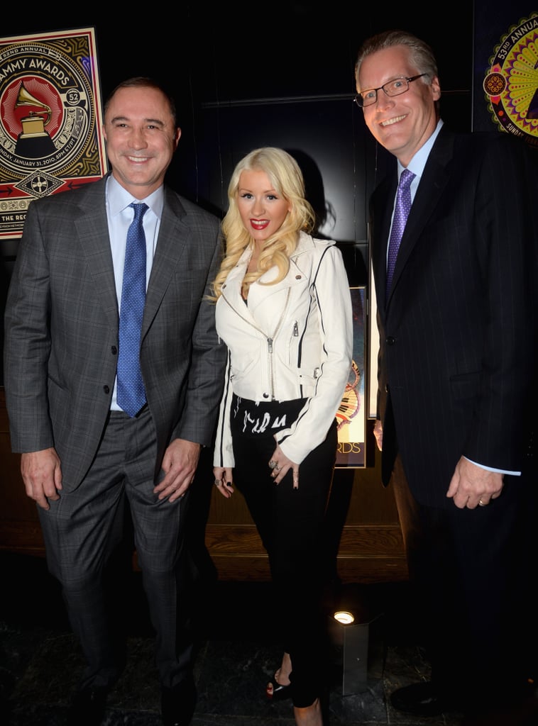 Christina Aguilera made an appearance at the Delta party, posing with two Delta execs.