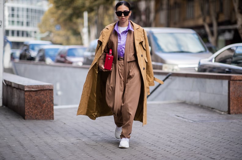 Wear Your Trench Coat Over Your Shoulders and Style It With Sneakers